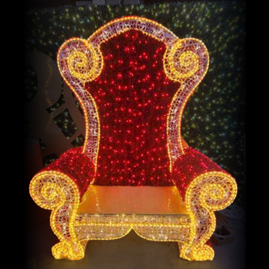 An illuminated red and gold throne lit for photographs.