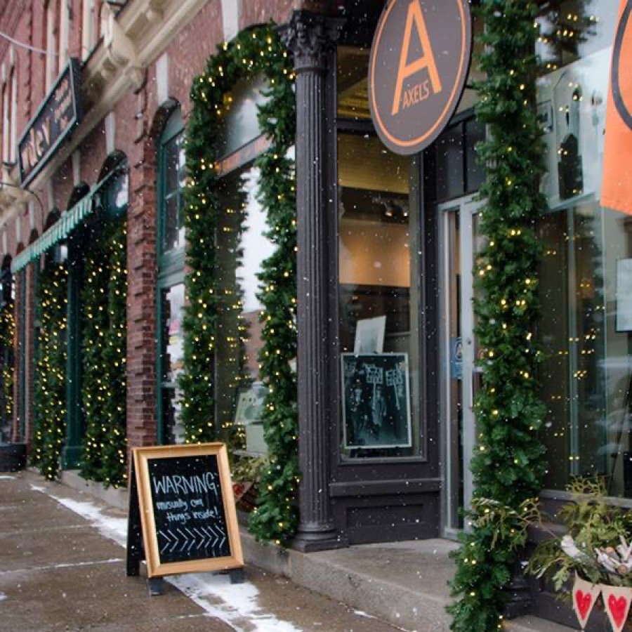 Lit garland running along a storefront frontage and windows.