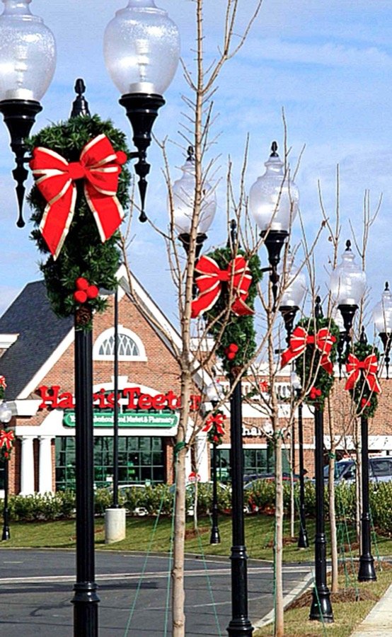 Traditional spray garland mounted on street poles along a road.
