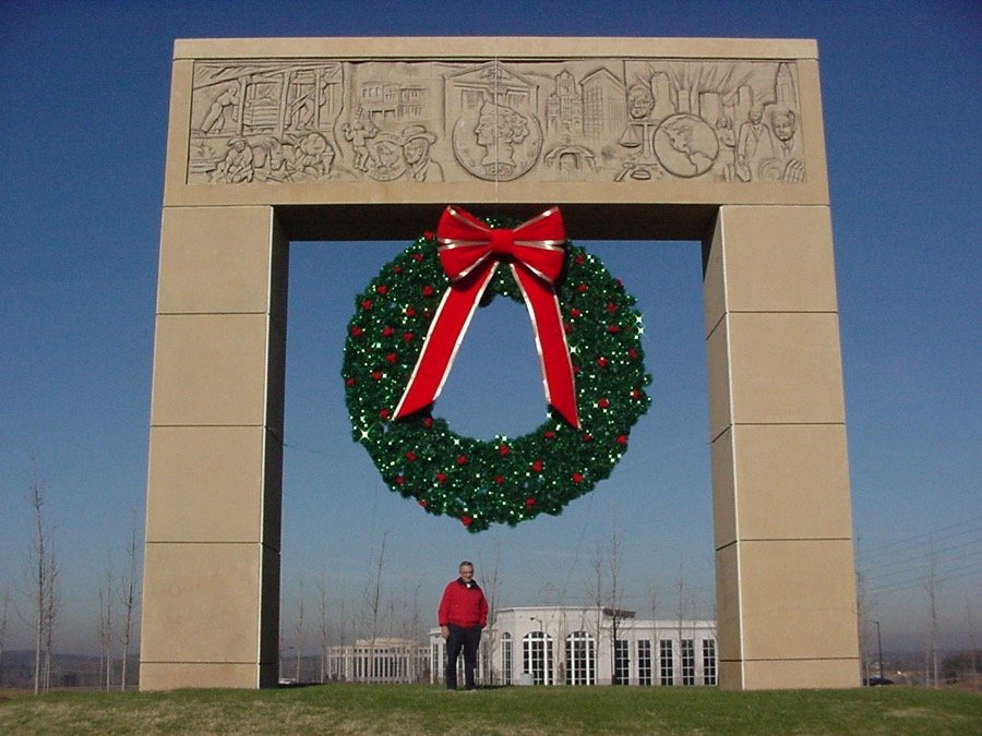 A giant commercial wreath mounted within a stone archway.