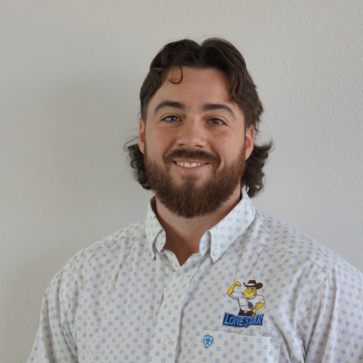 Michael Bremer, smiling, in a Lone Star Irrigation shirt